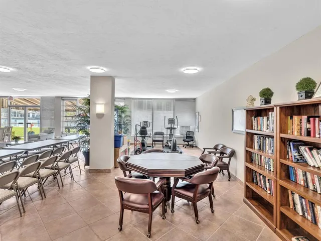 a view of a dining room with furniture and a book shelf