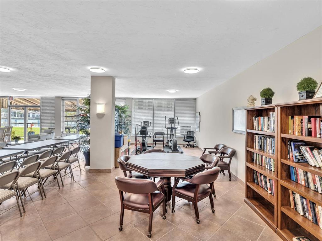 3100 South Ocean Boulevard, Unit 712 Highland Beach, FL 33487 - Photo 33 of 50 a view of a dining room with furniture and a book shelf