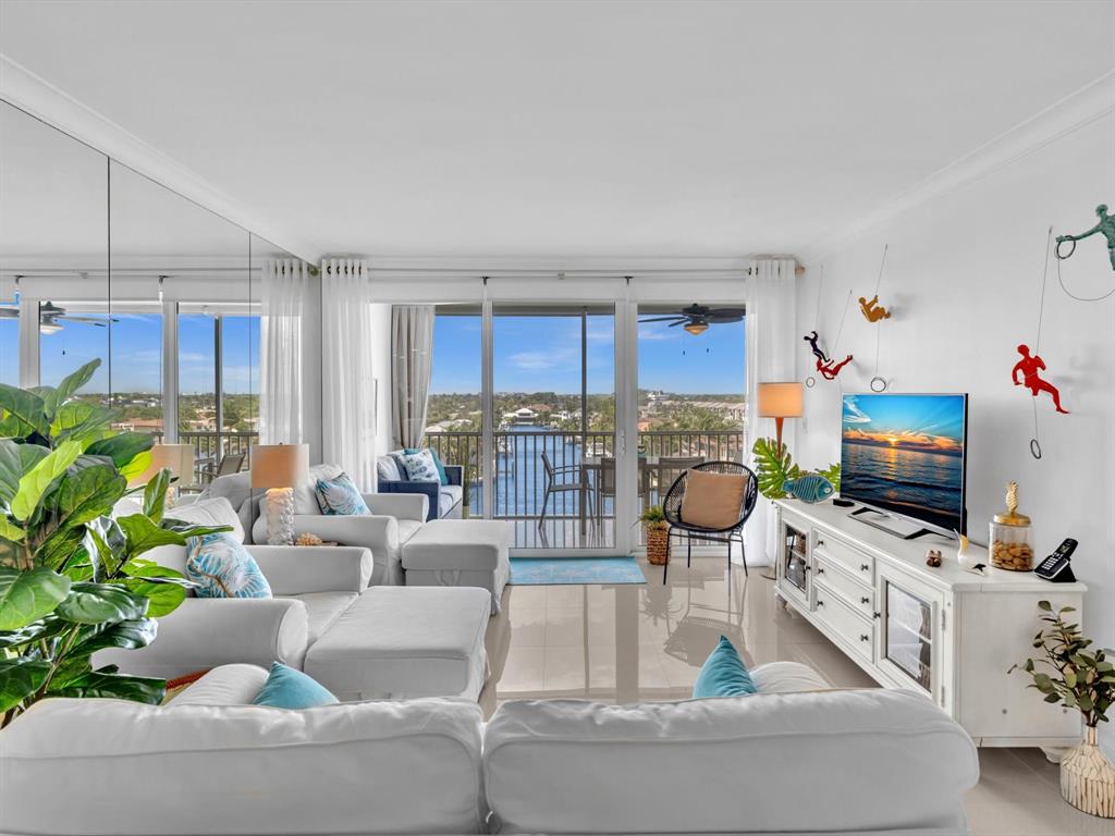 3100 South Ocean Boulevard, Unit 712 Highland Beach, FL 33487 - Photo 4 of 50 a living room with furniture a flat screen tv and a view of kitchen