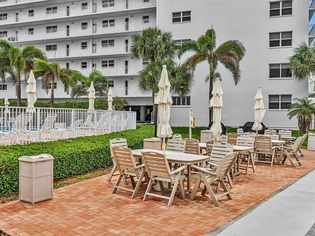 a view of a backyard with a patio and plants