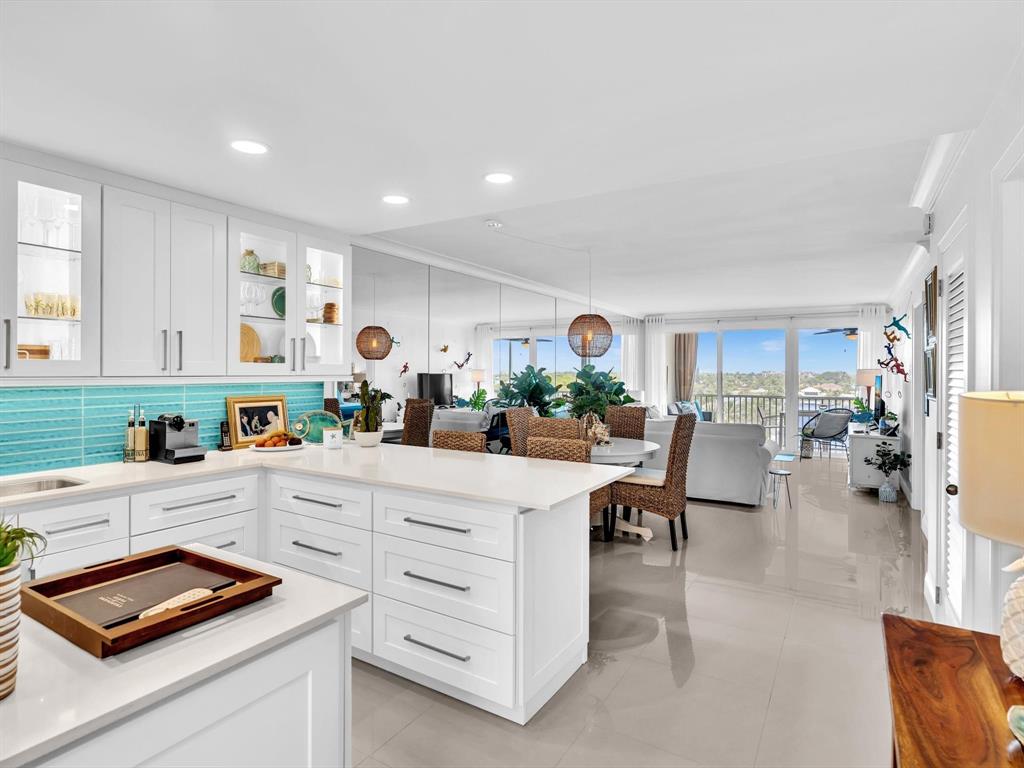 3100 South Ocean Boulevard, Unit 712 Highland Beach, FL 33487 - Photo 8 of 50 a kitchen with white cabinets and a stove with wooden floor
