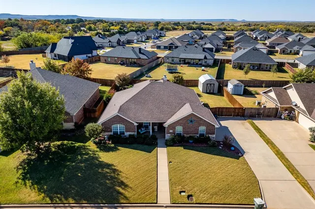an aerial view of residential houses with outdoor space