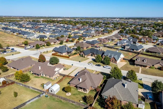 an aerial view of a city with lots of residential buildings and parking space