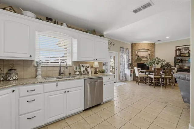 a kitchen with sink cabinets and dining table chair