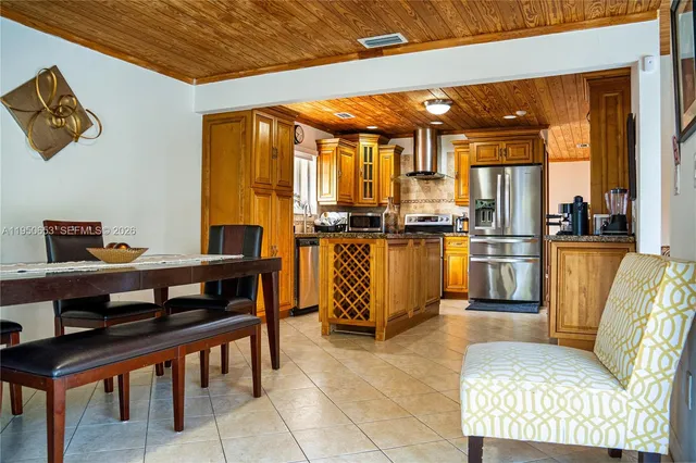 a living room with furniture a flat screen tv and a dining table