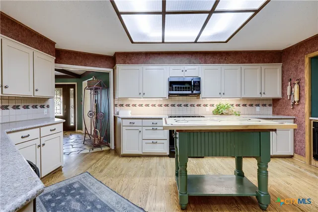 a kitchen with a stove a sink and a refrigerator