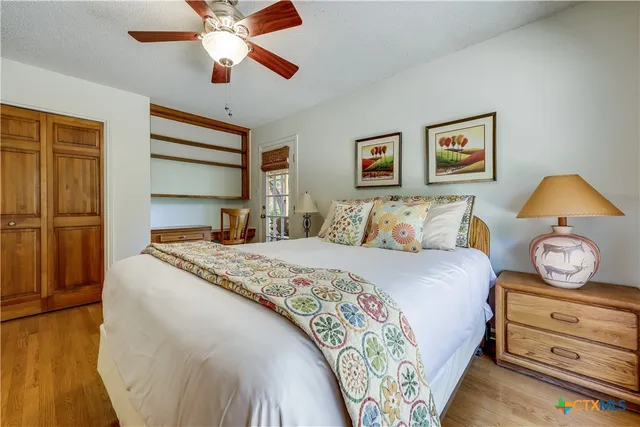 a bedroom with a large bed and a chandelier