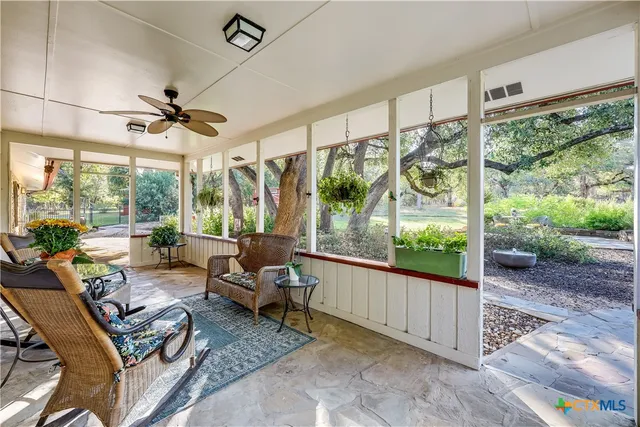 a view of a swimming pool with a yard and plants