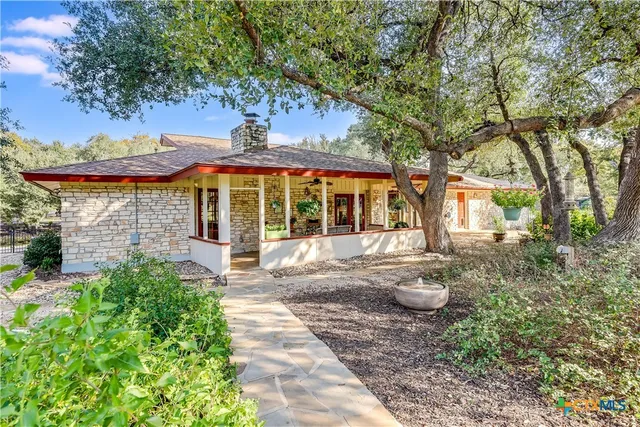 a front view of a house with yard and green space