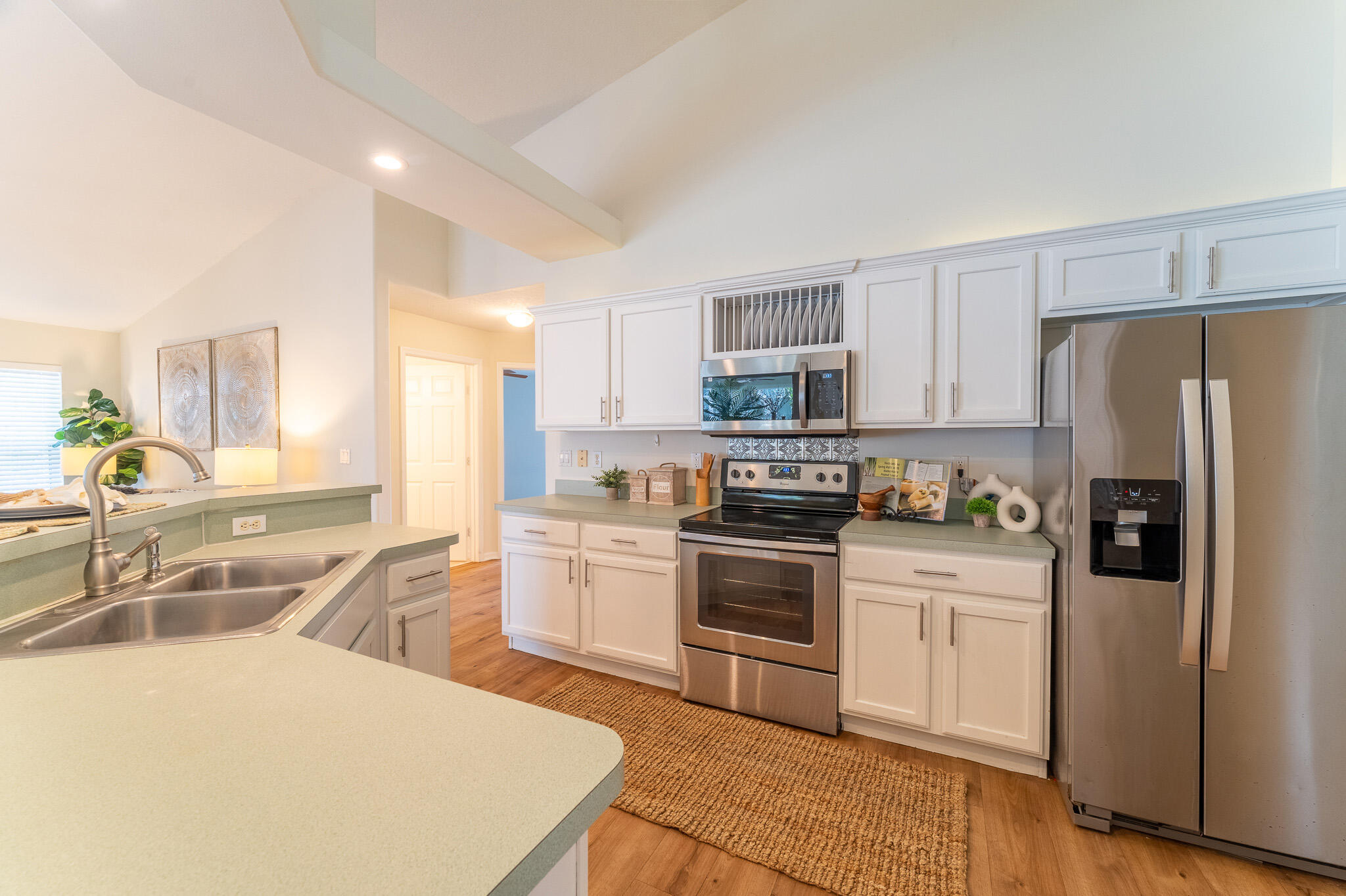 513 Southeast Cliff Road Port St. Lucie, FL 34984 - Photo 12 of 31 a kitchen with granite countertop a refrigerator stove top oven and sink