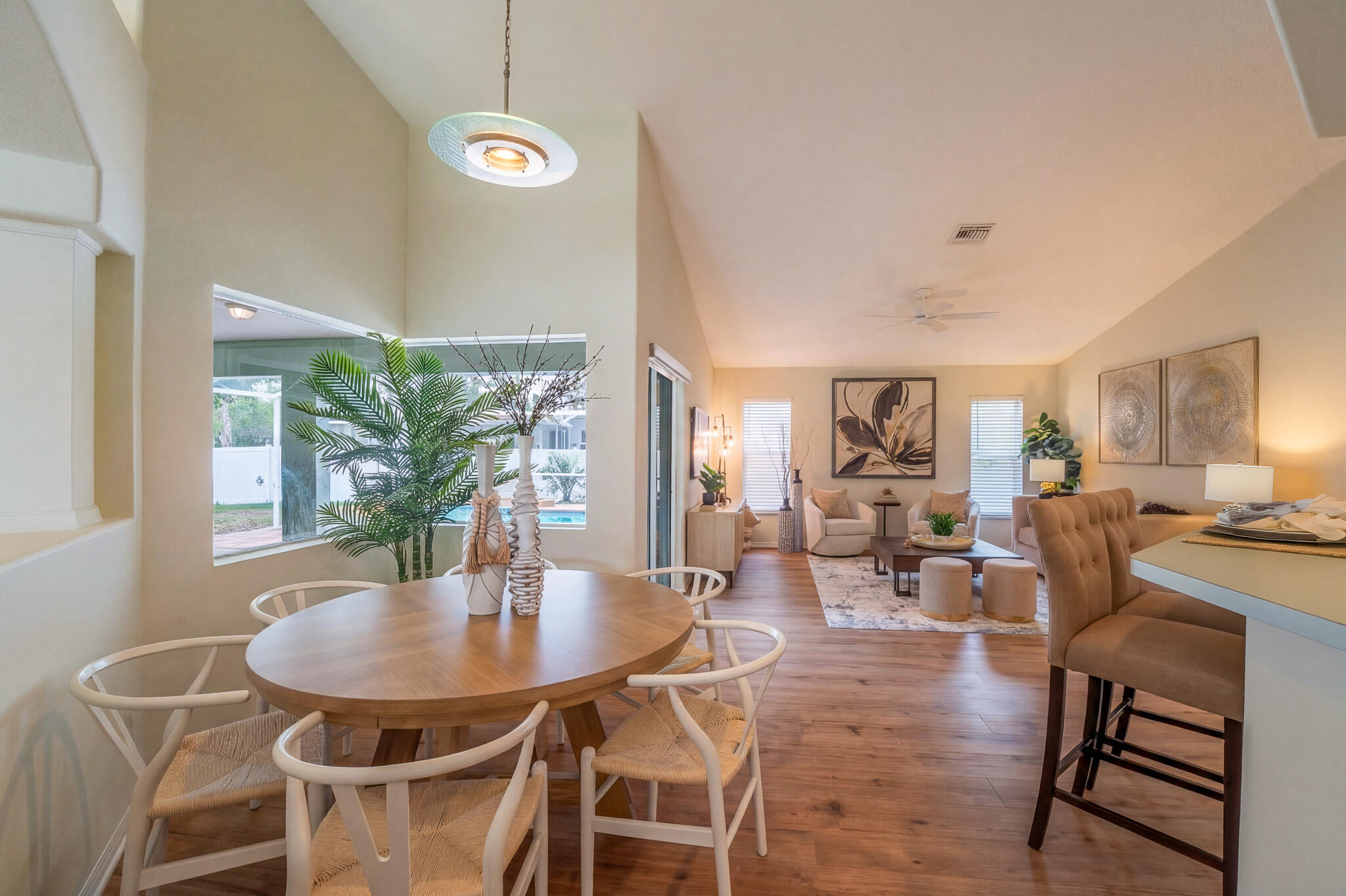 513 Southeast Cliff Road Port St. Lucie, FL 34984 - Photo 16 of 31 a view of a dining room with furniture and wooden floor