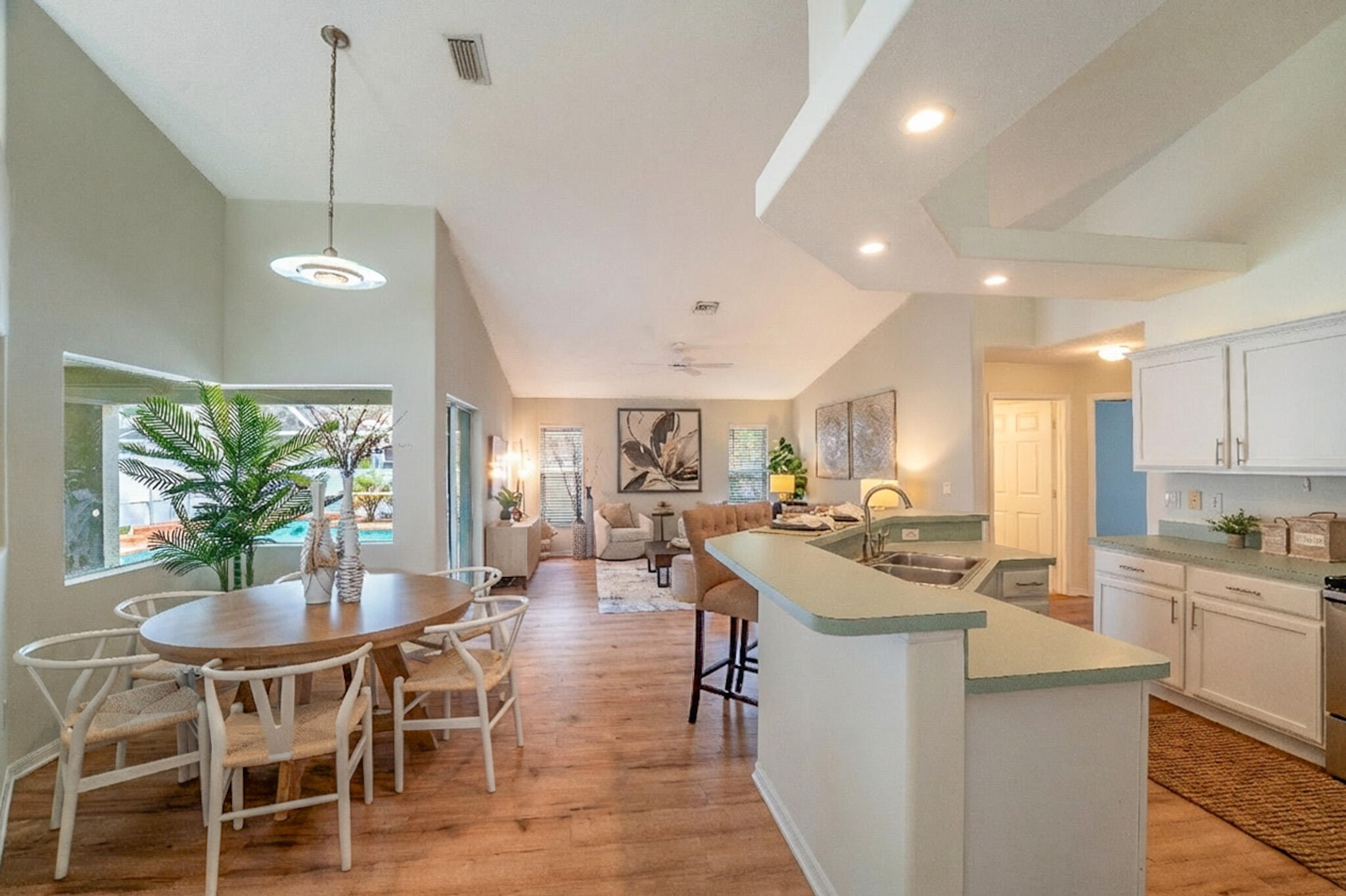 513 Southeast Cliff Road Port St. Lucie, FL 34984 - Photo 17 of 31 a kitchen with a dining table chairs stainless steel appliances and cabinets