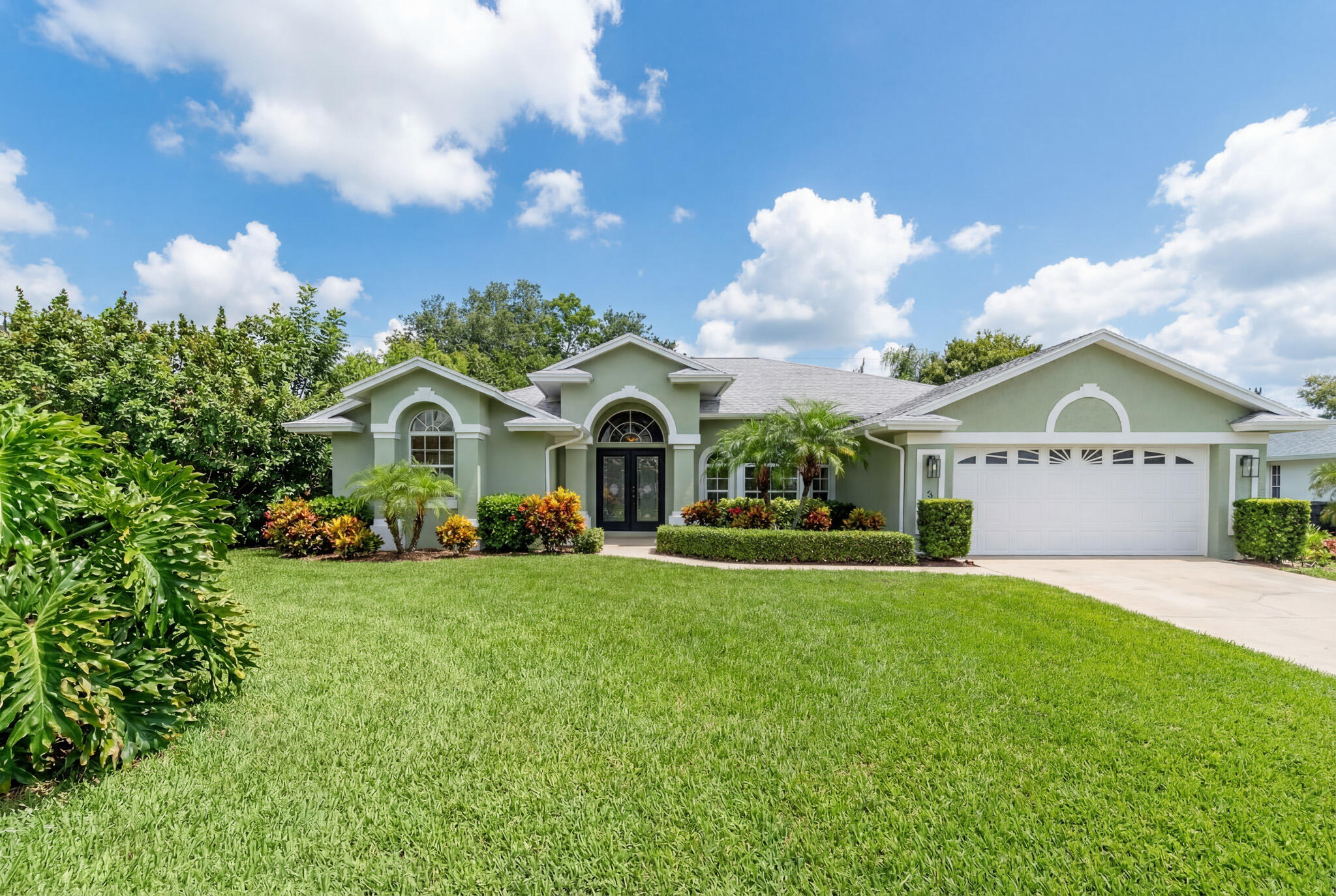 513 Southeast Cliff Road Port St. Lucie, FL 34984 - Photo 2 of 31 a view of a house with a yard and potted plants
