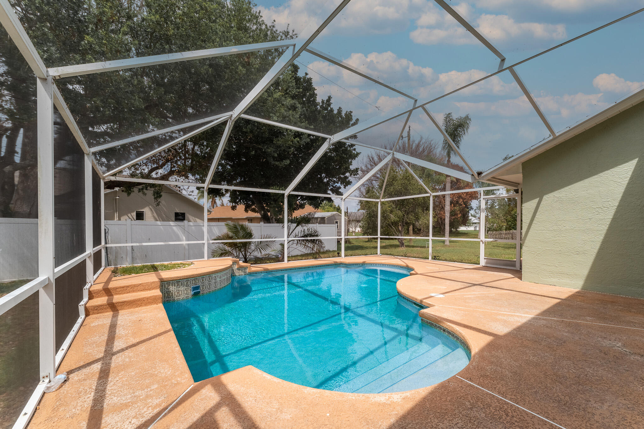 513 Southeast Cliff Road Port St. Lucie, FL 34984 - Photo 27 of 31 a view of a swimming pool with a patio and yard