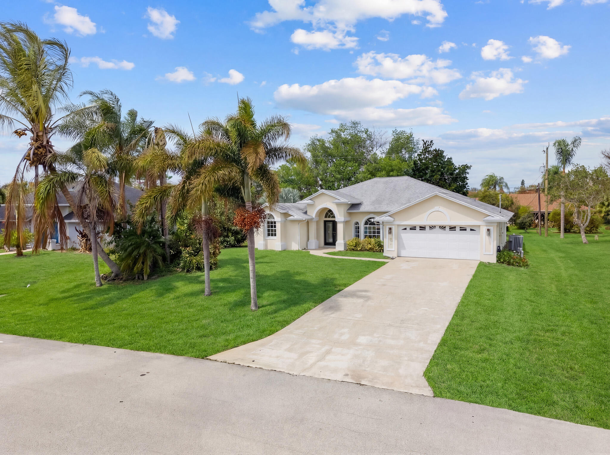 513 Southeast Cliff Road Port St. Lucie, FL 34984 - Photo 29 of 31 a view of a house with a yard