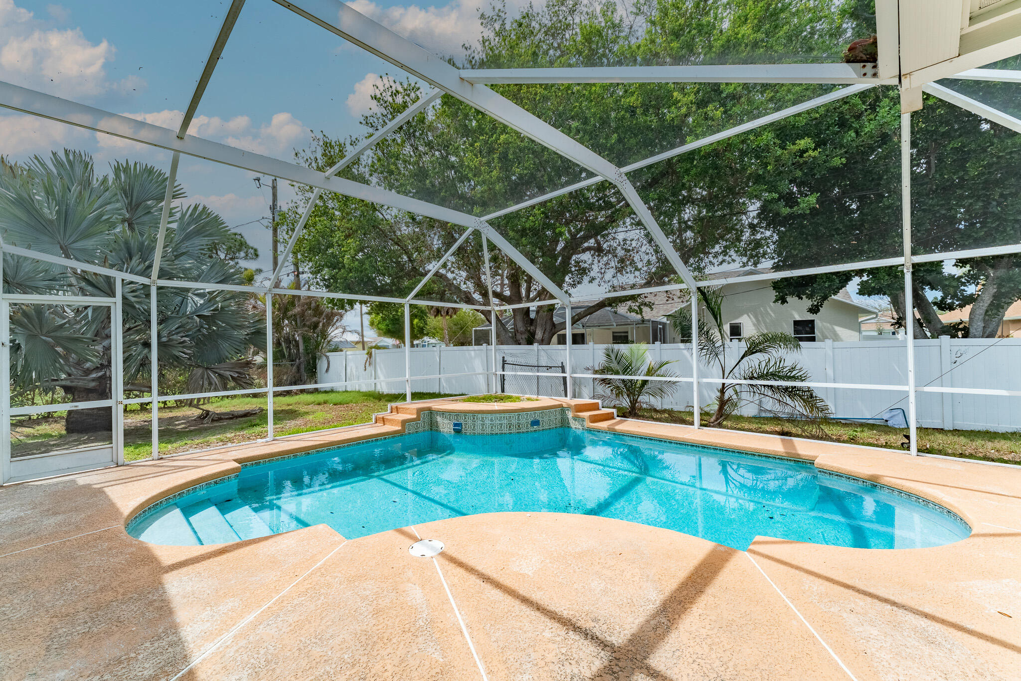 513 Southeast Cliff Road Port St. Lucie, FL 34984 - Photo 3 of 31 a view of a backyard with a small swimming pool