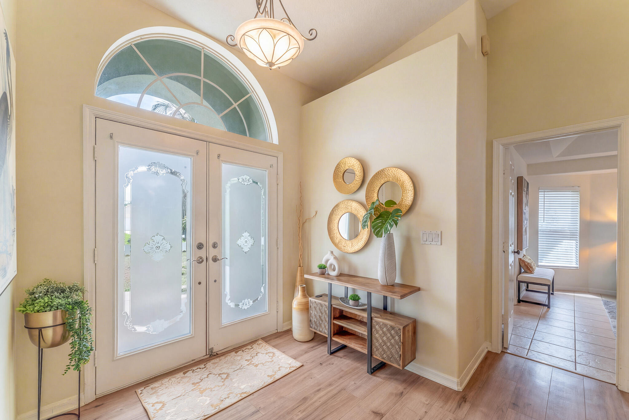 513 Southeast Cliff Road Port St. Lucie, FL 34984 - Photo 4 of 31 an entryway with wooden floor and mirror