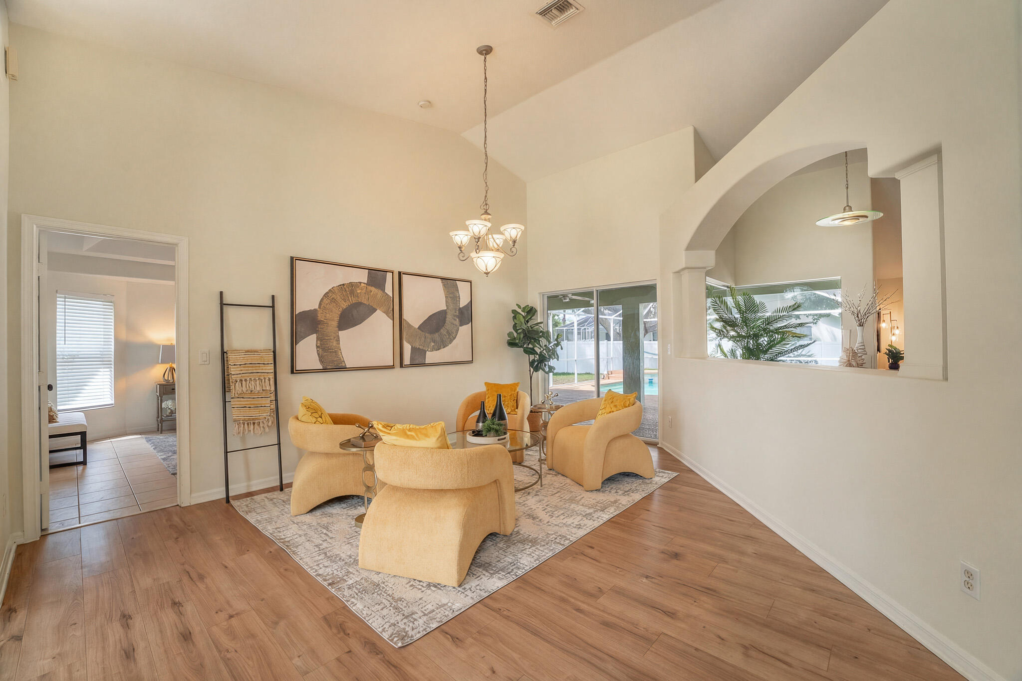 513 Southeast Cliff Road Port St. Lucie, FL 34984 - Photo 5 of 31 a dining room with wooden floor a glass table and chairs