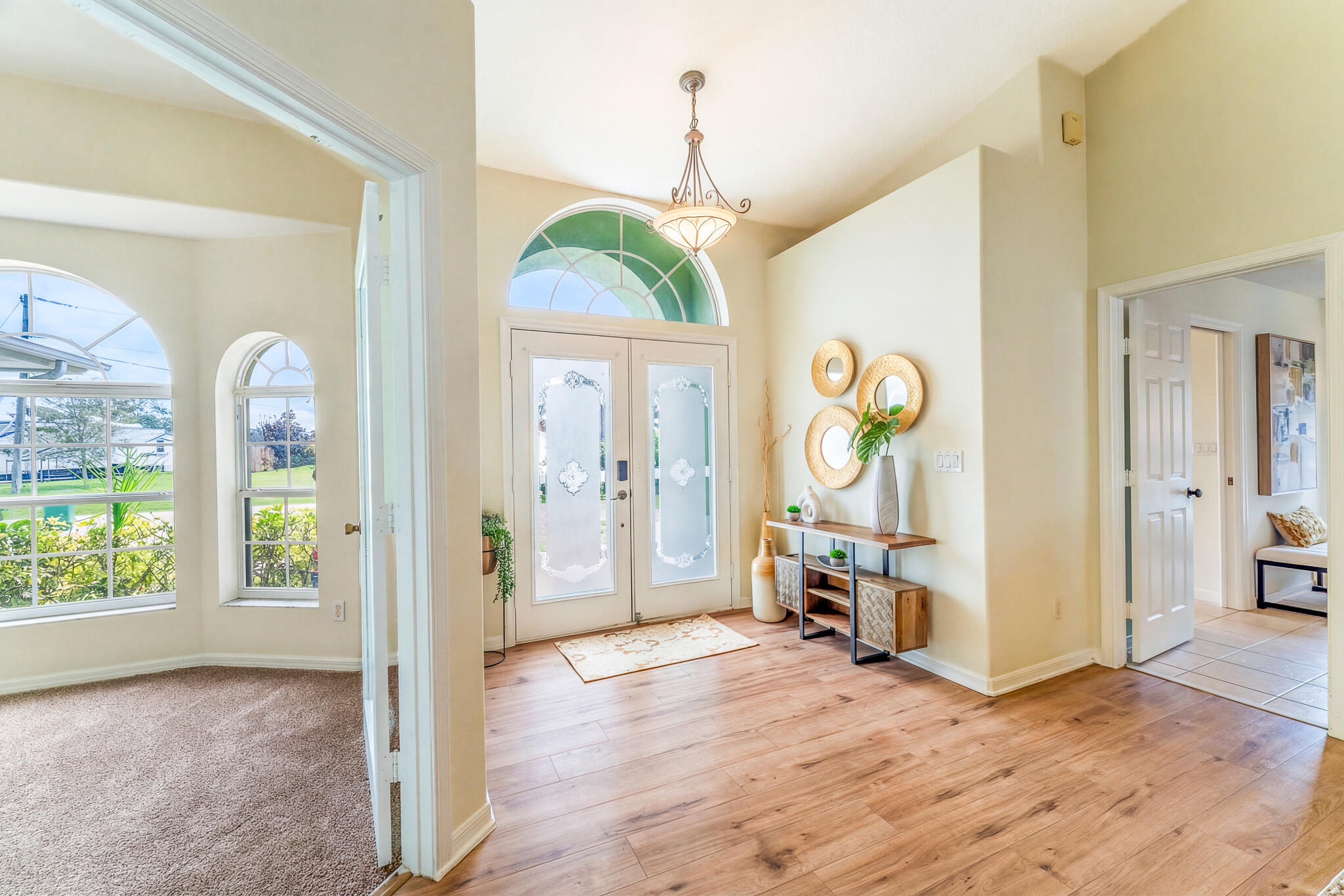 513 Southeast Cliff Road Port St. Lucie, FL 34984 - Photo 7 of 31 a view of a bedroom with wooden floor and windows