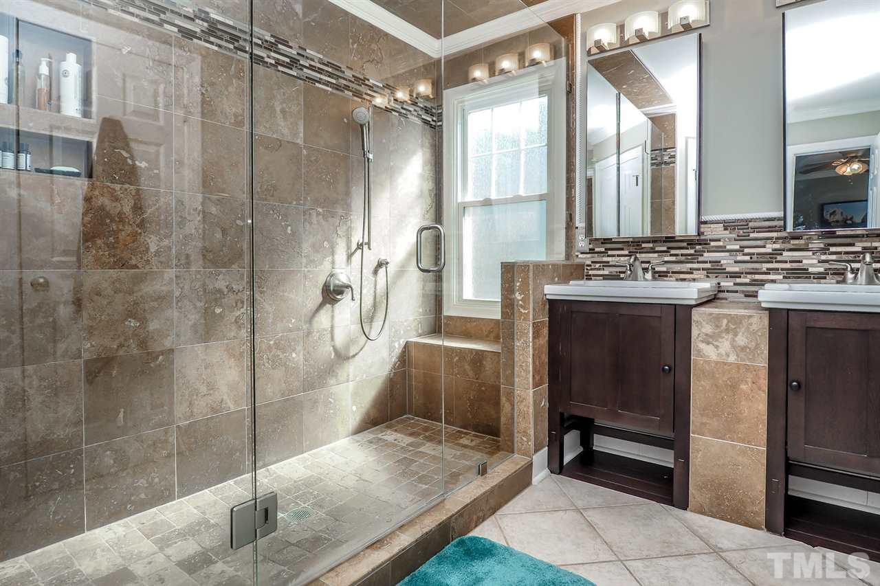 2028 Muirfield Village Way Raleigh, NC 27604 - Photo 12 of 20 Seamless showering in the tile bath with top-of-the-line cabinetry and vanities.