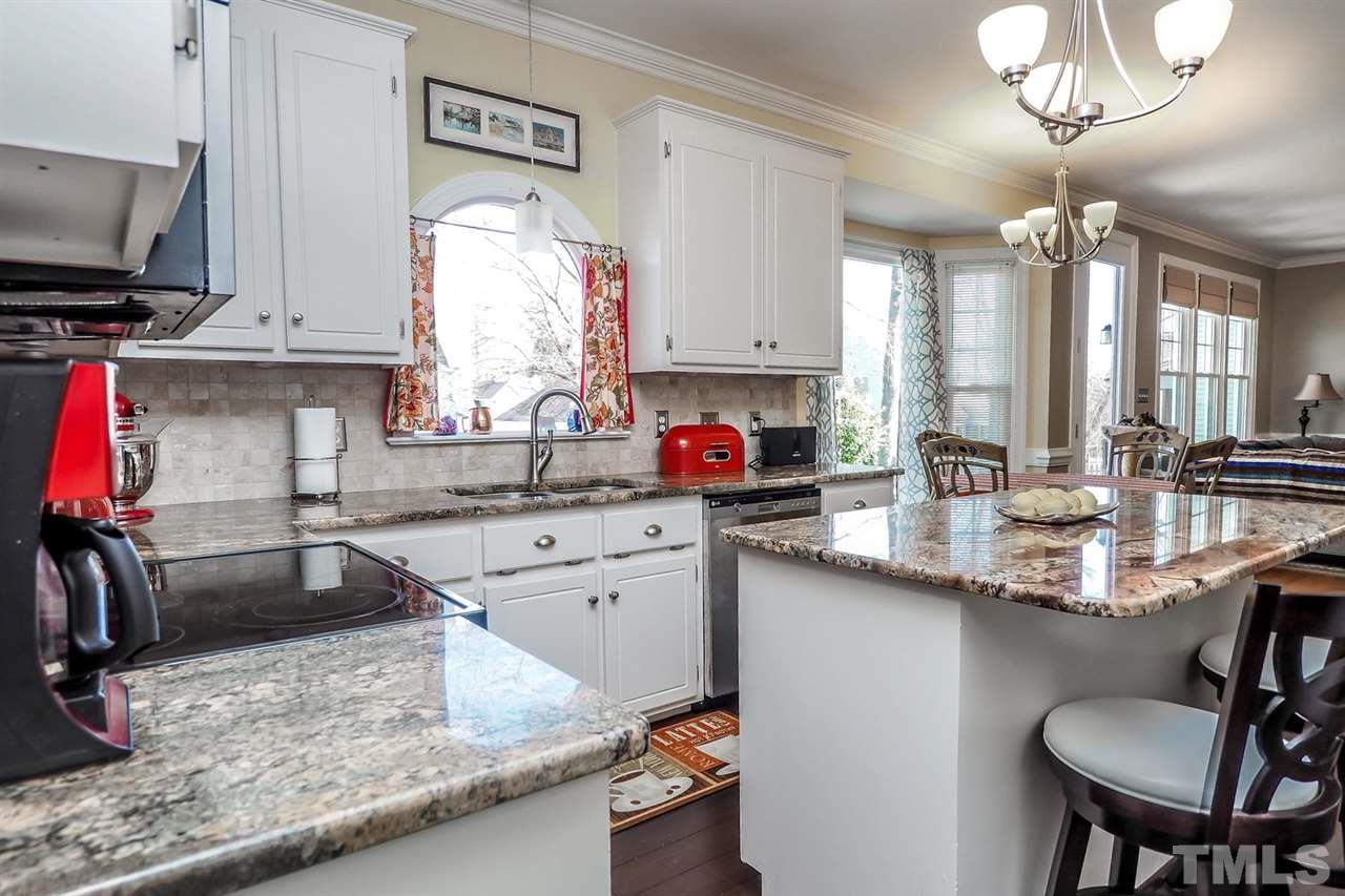 2028 Muirfield Village Way Raleigh, NC 27604 - Photo 8 of 20 The kitchen is open to the breakfast room and family room.