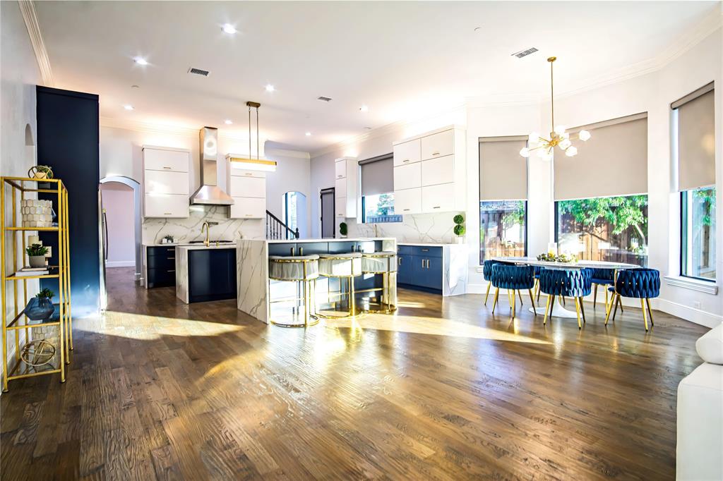10545 Rogers Road Frisco, TX 75033 - Photo 13 of 40 a living room with stainless steel appliances kitchen island granite countertop a table chairs and a view of living room