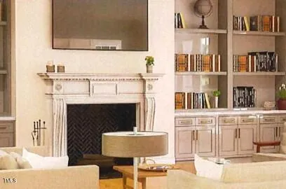 a living room with a fireplace and a flat screen tv