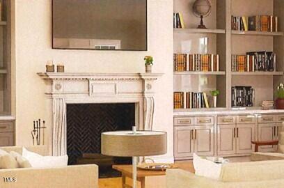 1521 Canterbury Road Raleigh, NC 27608 - Photo 5 of 7 a living room with a fireplace and a flat screen tv