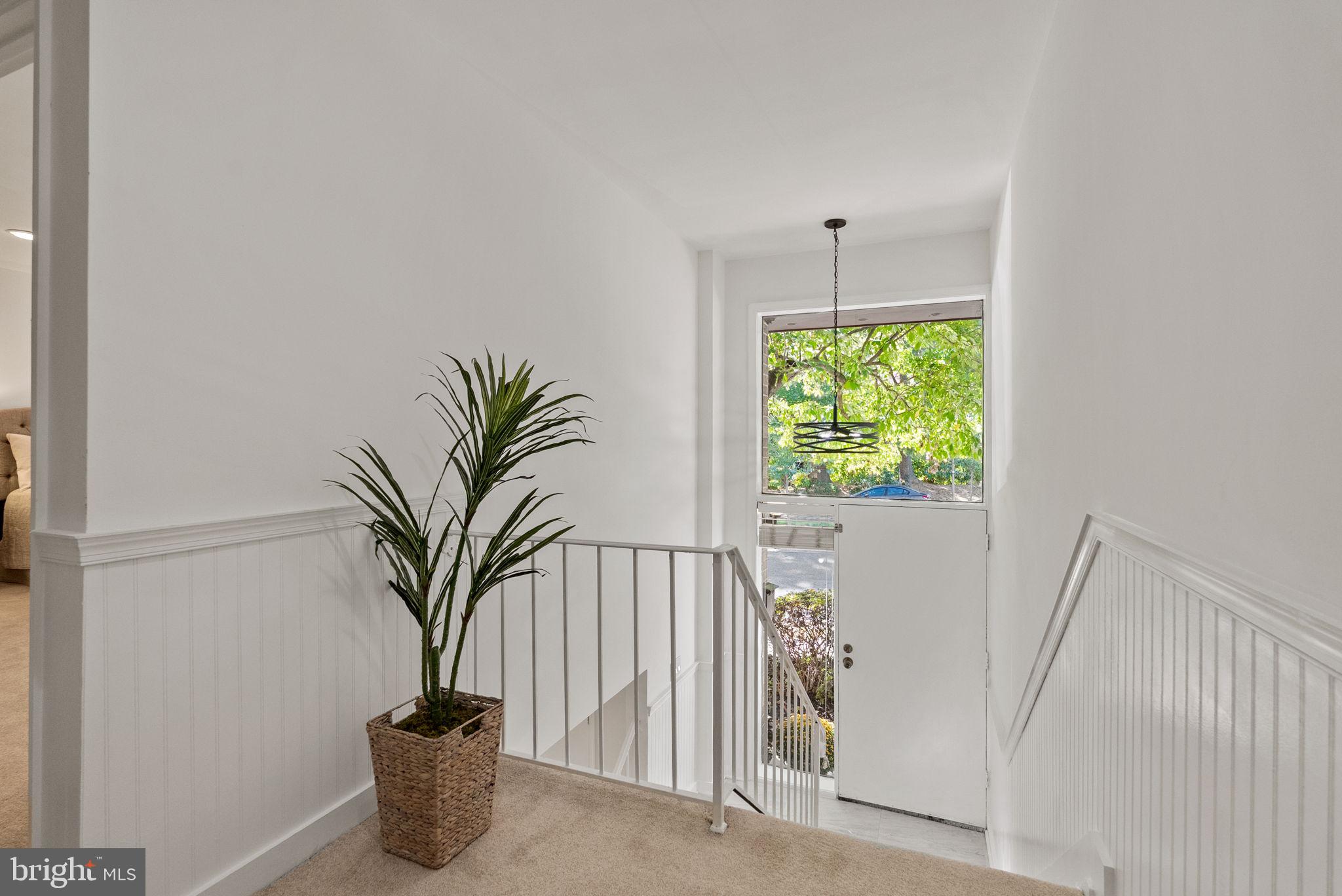 11026 Saffold Way Reston, VA 20190 - Photo 11 of 30 a vase of flowers sitting on a floor in front of a door