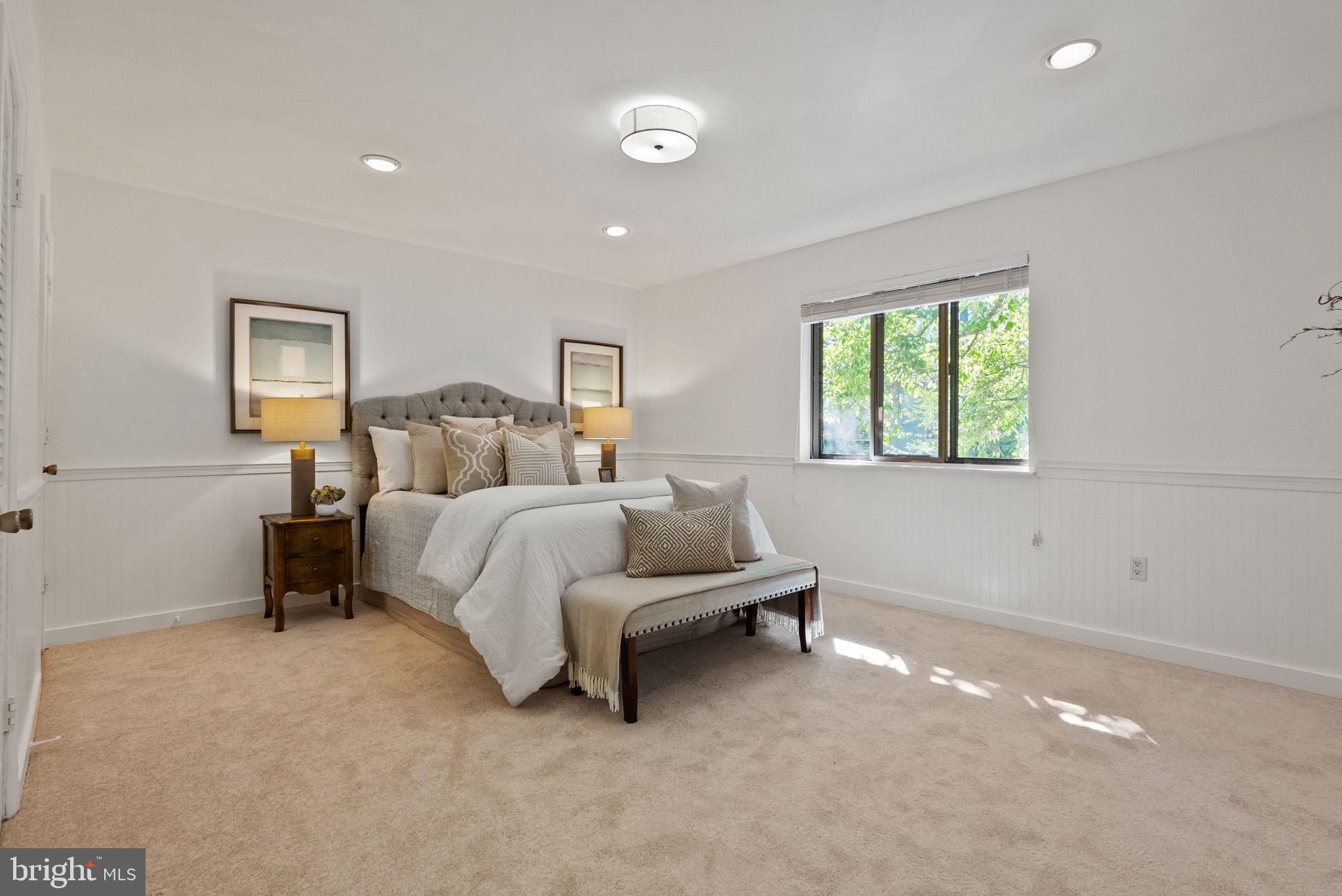 11026 Saffold Way Reston, VA 20190 - Photo 12 of 30 a bedroom with a bed and a night stand