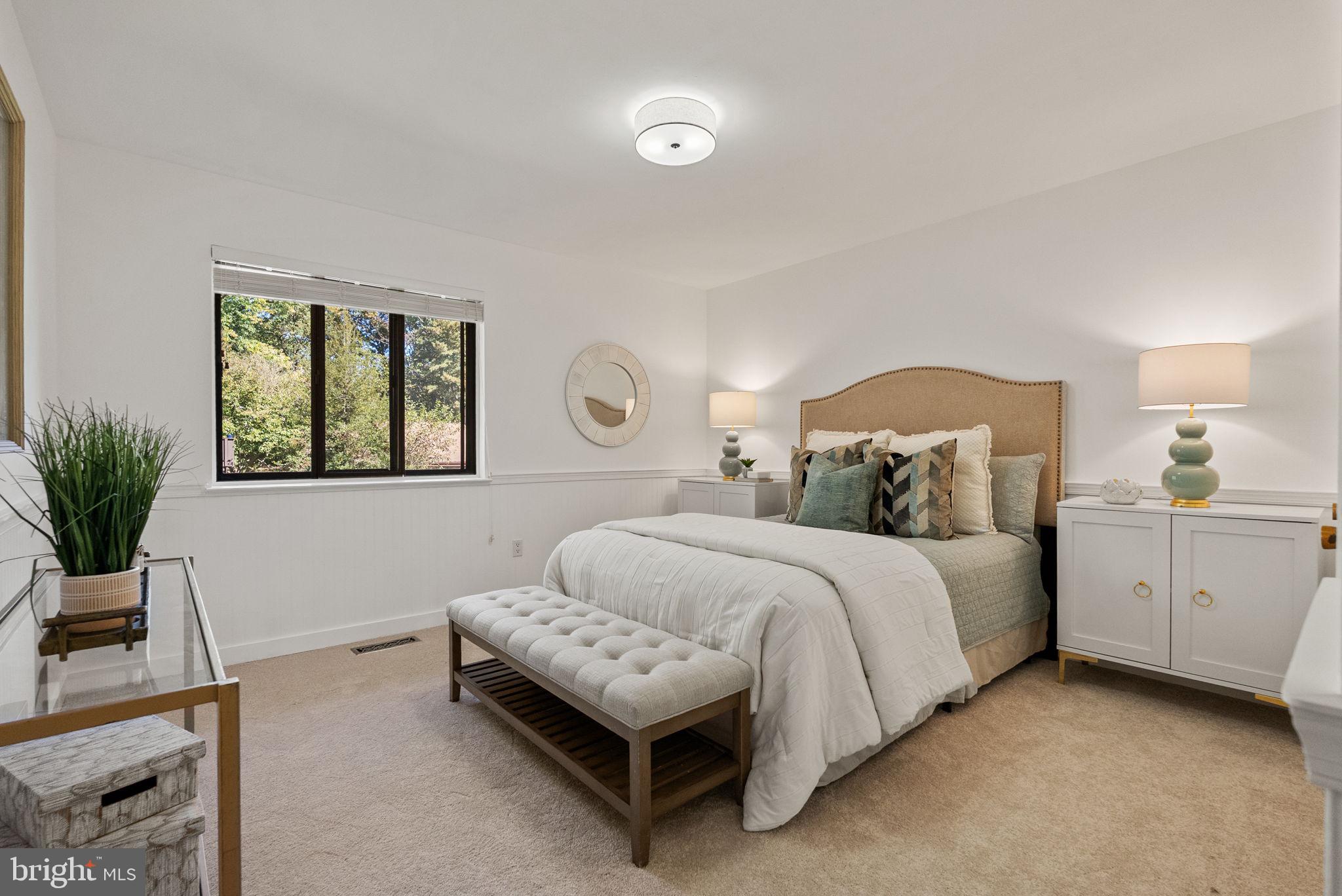 11026 Saffold Way Reston, VA 20190 - Photo 15 of 30 a bedroom with a bed and a window