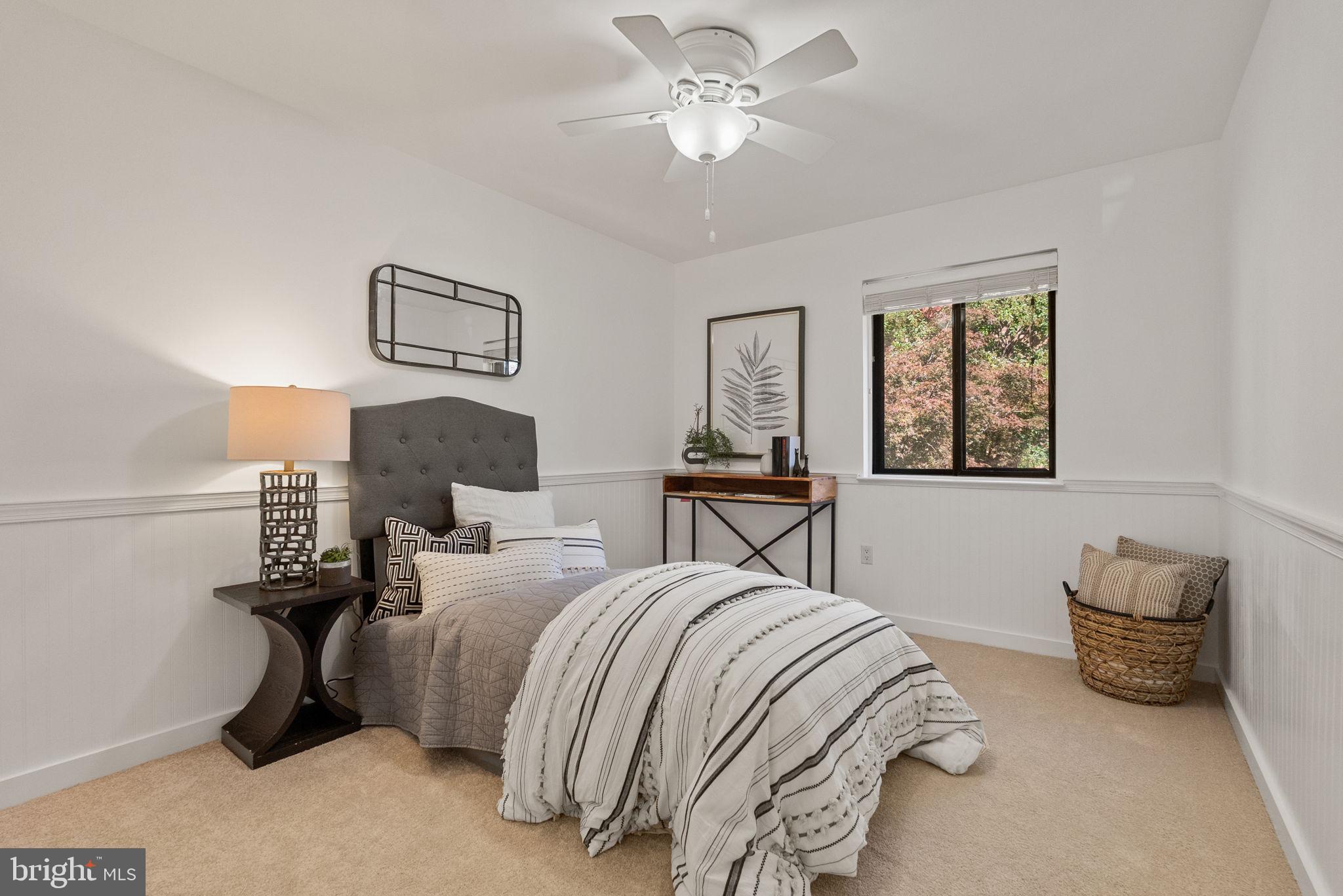 11026 Saffold Way Reston, VA 20190 - Photo 16 of 30 a bedroom with bed and a chandelier