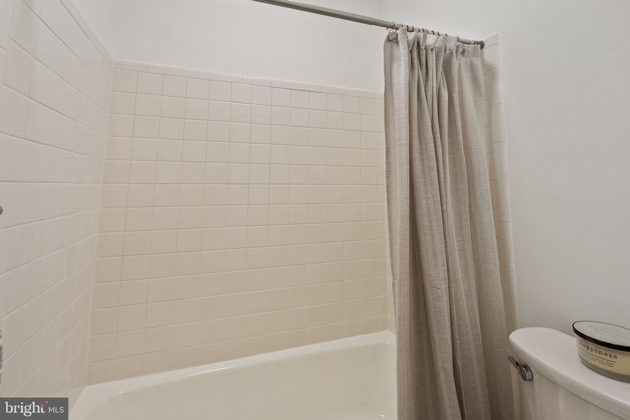 11026 Saffold Way Reston, VA 20190 - Photo 18 of 30 a bathroom with a shower and a toilet