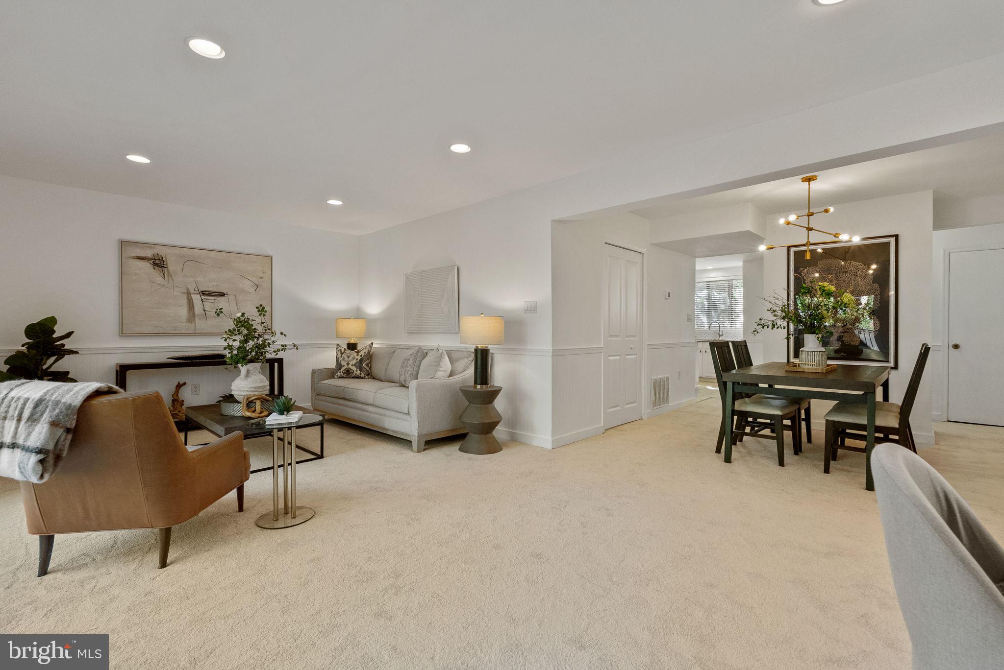11026 Saffold Way Reston, VA 20190 - Photo 24 of 30 a living room with furniture and a dining table with kitchen appliances