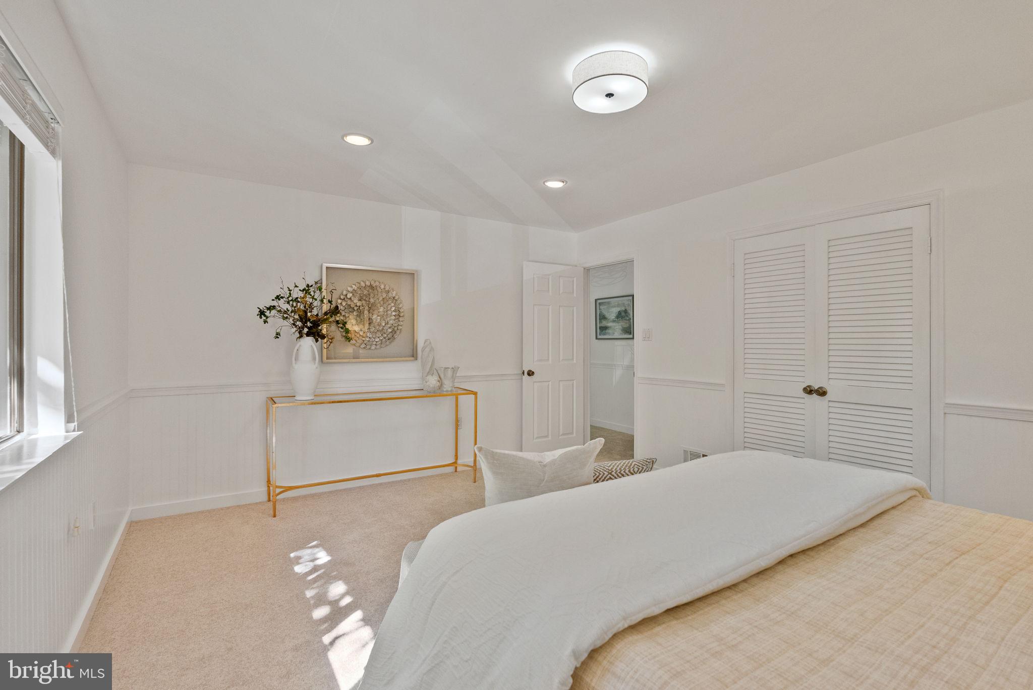 11026 Saffold Way Reston, VA 20190 - Photo 26 of 30 a bedroom with a bed and a dresser