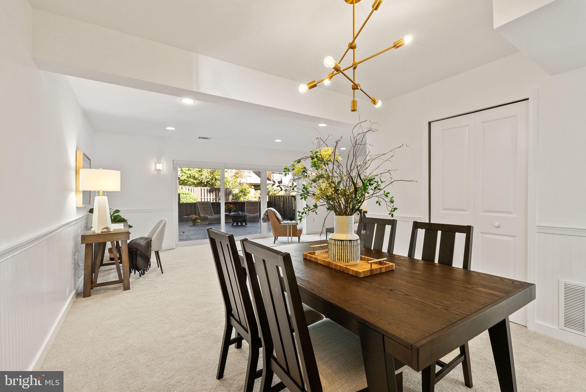 11026 Saffold Way Reston, VA 20190 - Photo 5 of 30 a view of a dining room with furniture and a potted plant