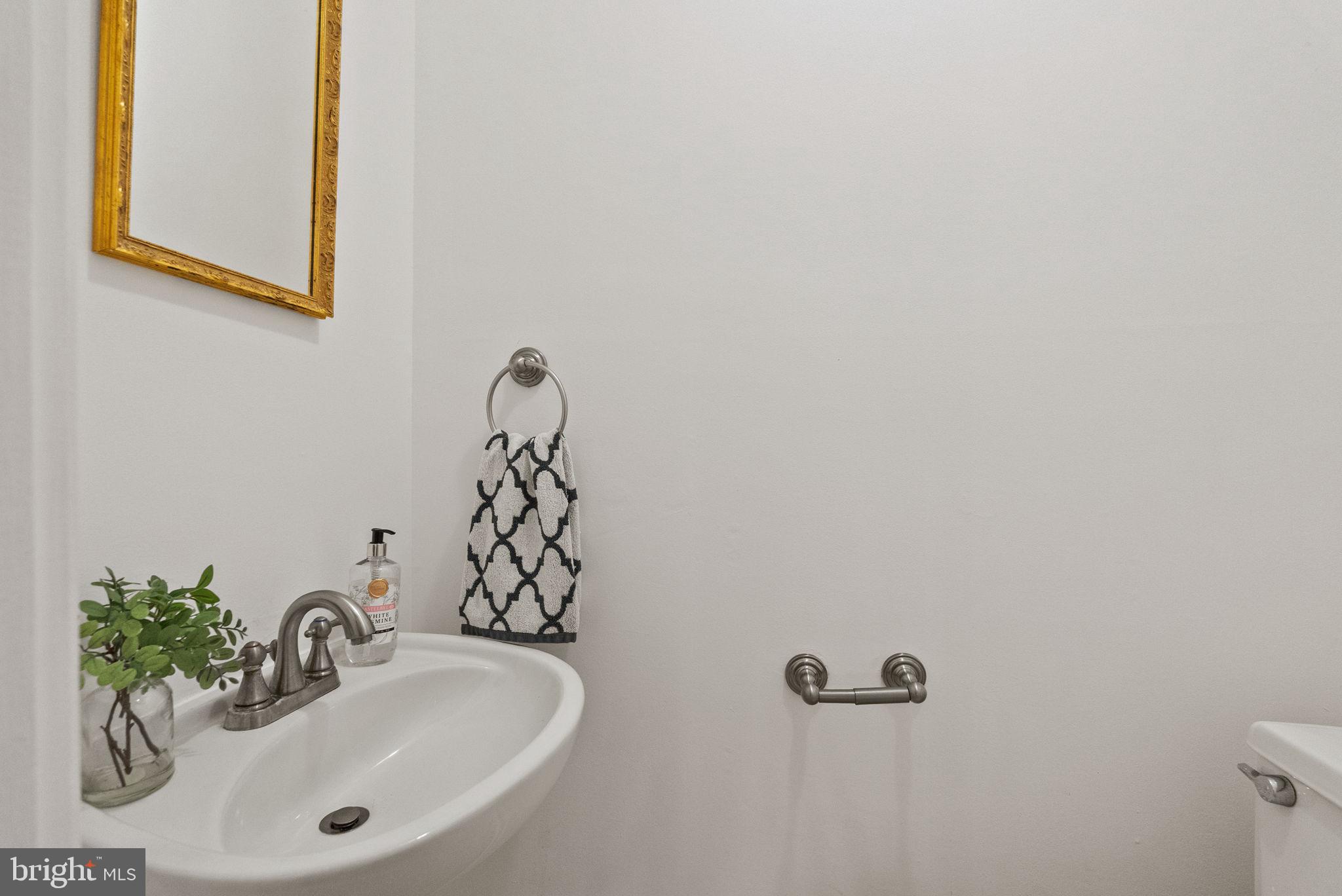 11026 Saffold Way Reston, VA 20190 - Photo 10 of 30 a bathroom with a sink and a mirror