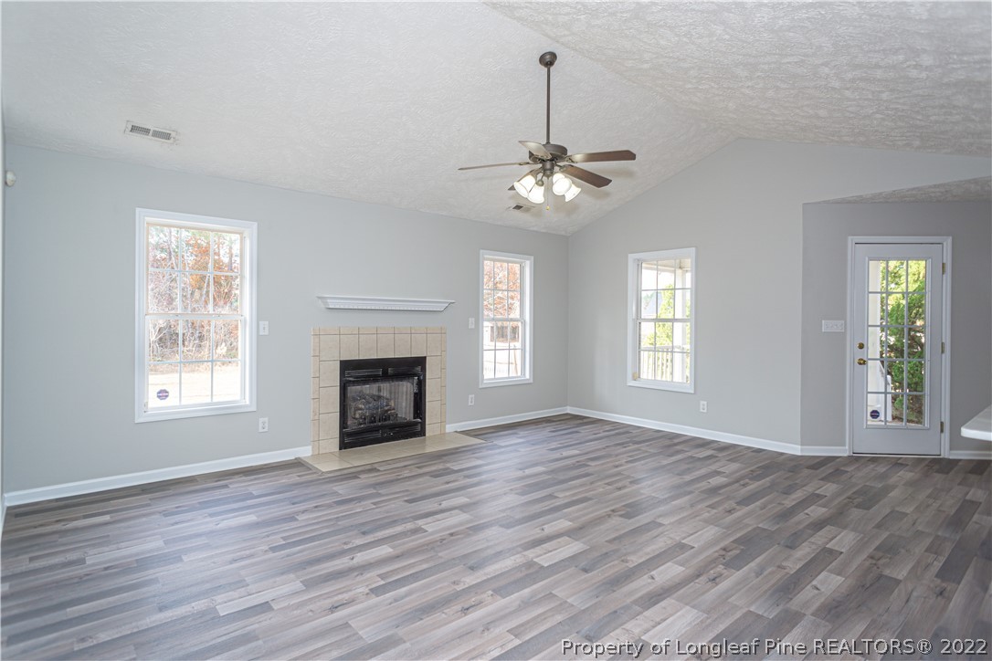5622 Spreading Branch Road Hope Mills, NC 28348 - Photo 8 of 40 a view of an empty room with exposed radiator and fireplace