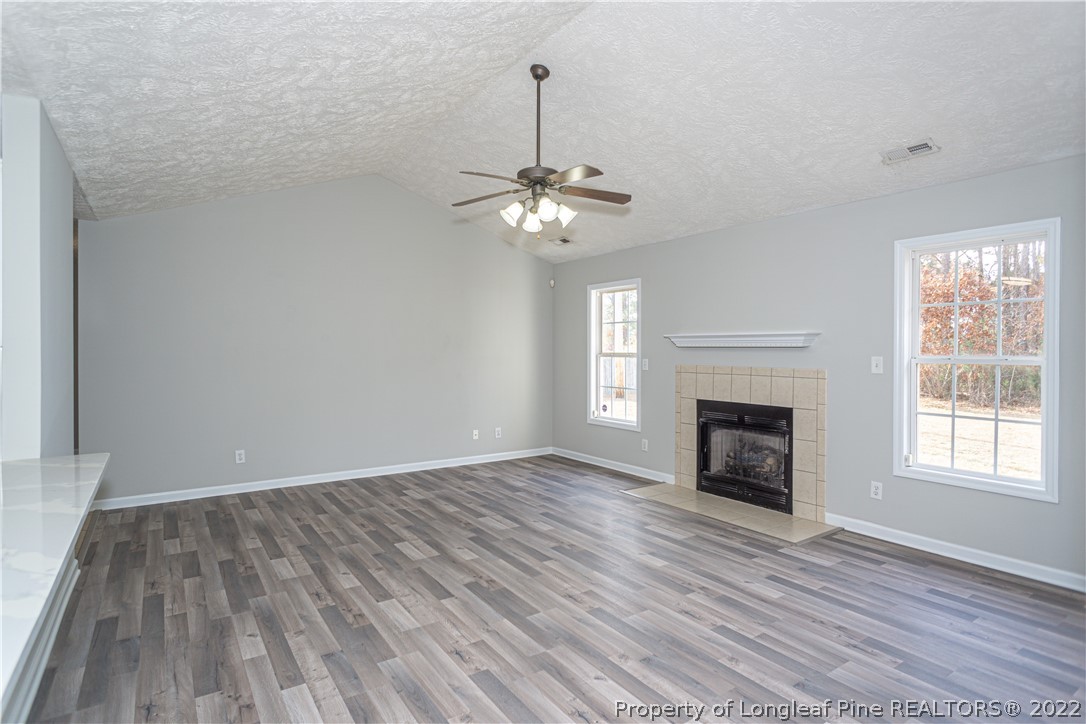 5622 Spreading Branch Road Hope Mills, NC 28348 - Photo 9 of 40 wooden floor in an empty room with a window