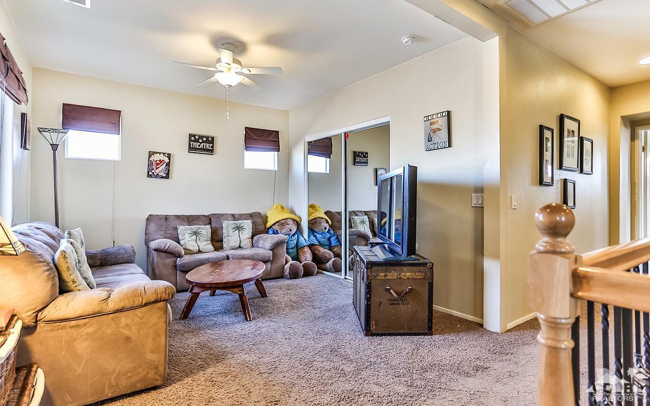 83330 Lightning Road Indio, CA 92203 - Photo 20 of 39 a living room with furniture and a flat screen tv
