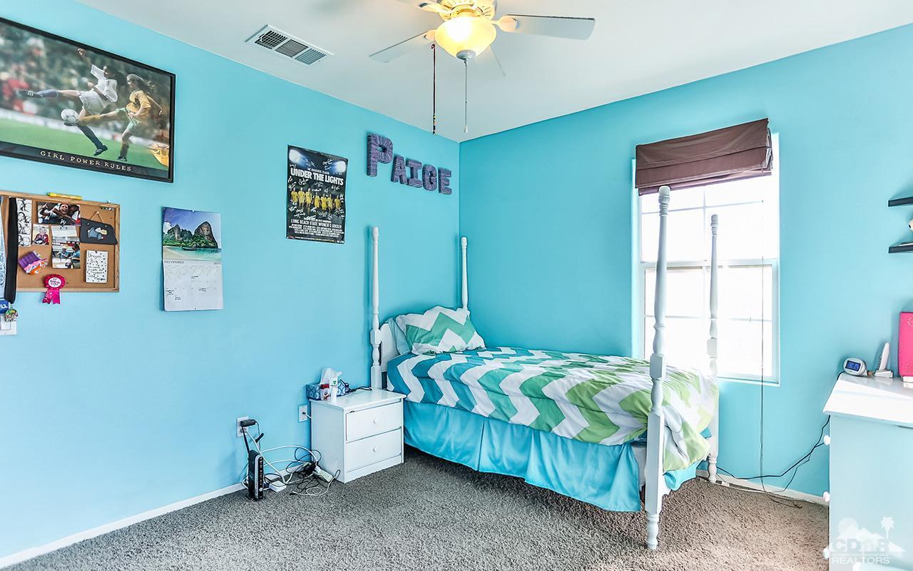 83330 Lightning Road Indio, CA 92203 - Photo 23 of 39 a bedroom with a bed and a chandelier