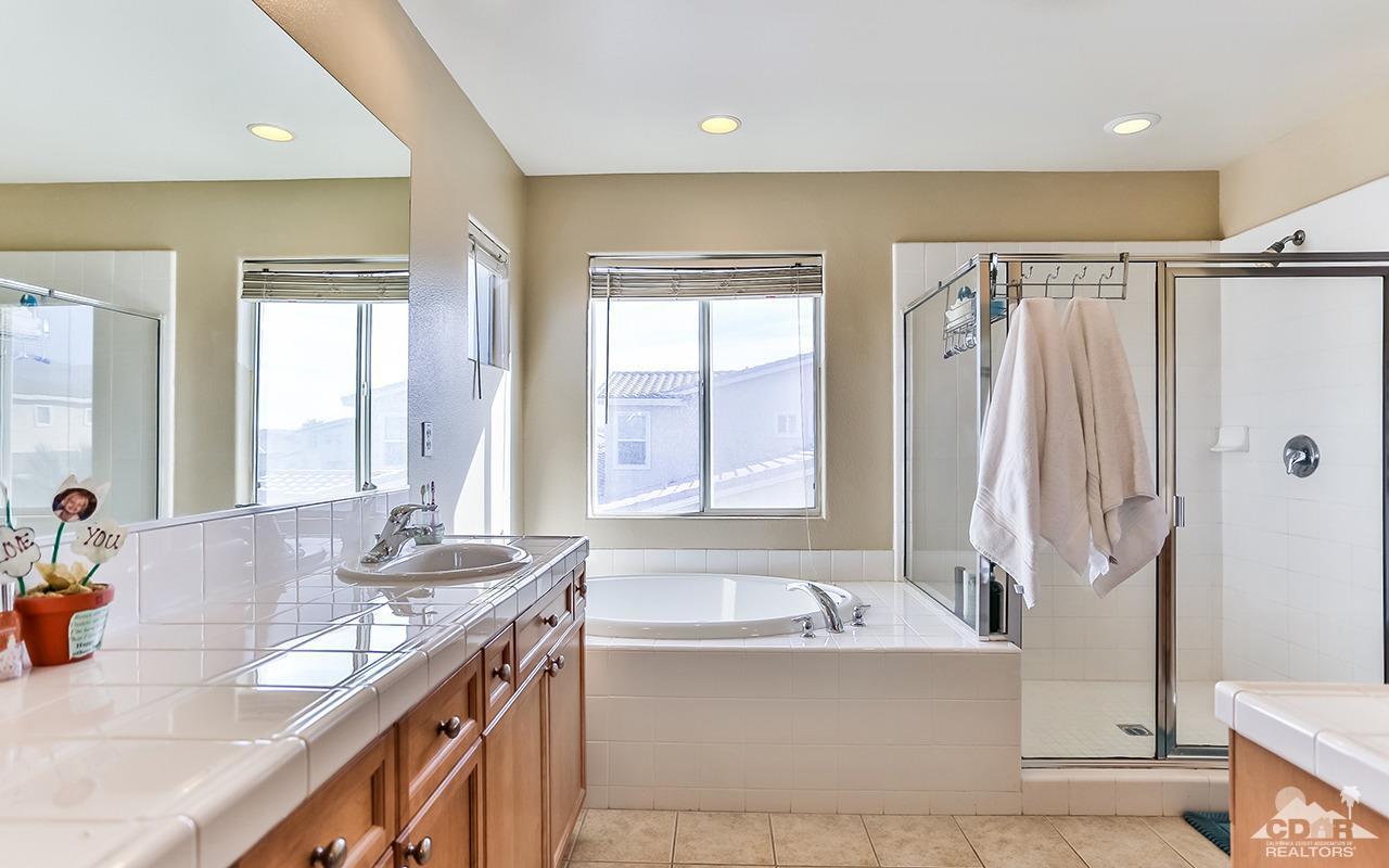 83330 Lightning Road Indio, CA 92203 - Photo 29 of 39 a bathroom with a granite countertop tub sink and mirror