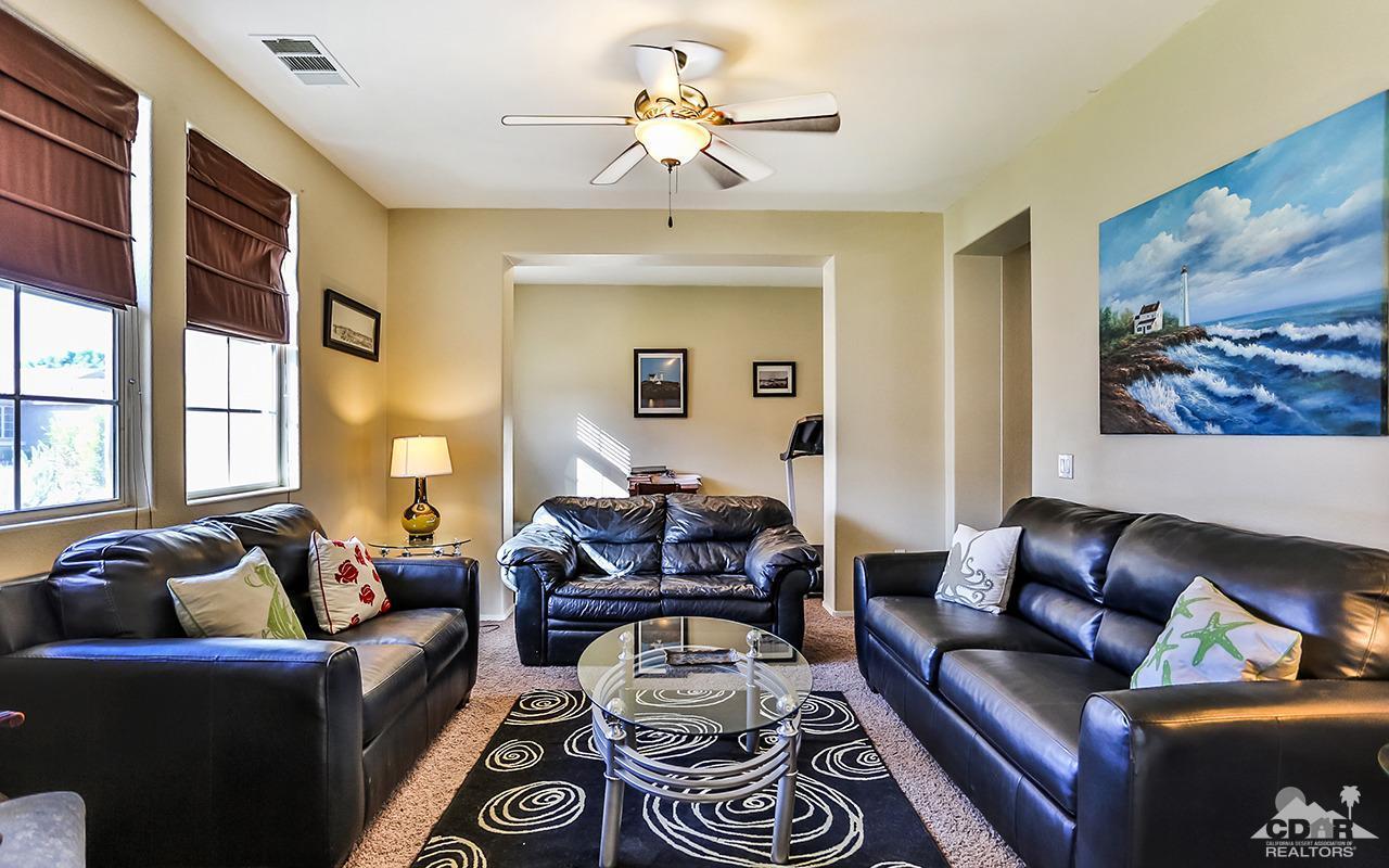 83330 Lightning Road Indio, CA 92203 - Photo 3 of 39 a living room with furniture and a chandelier