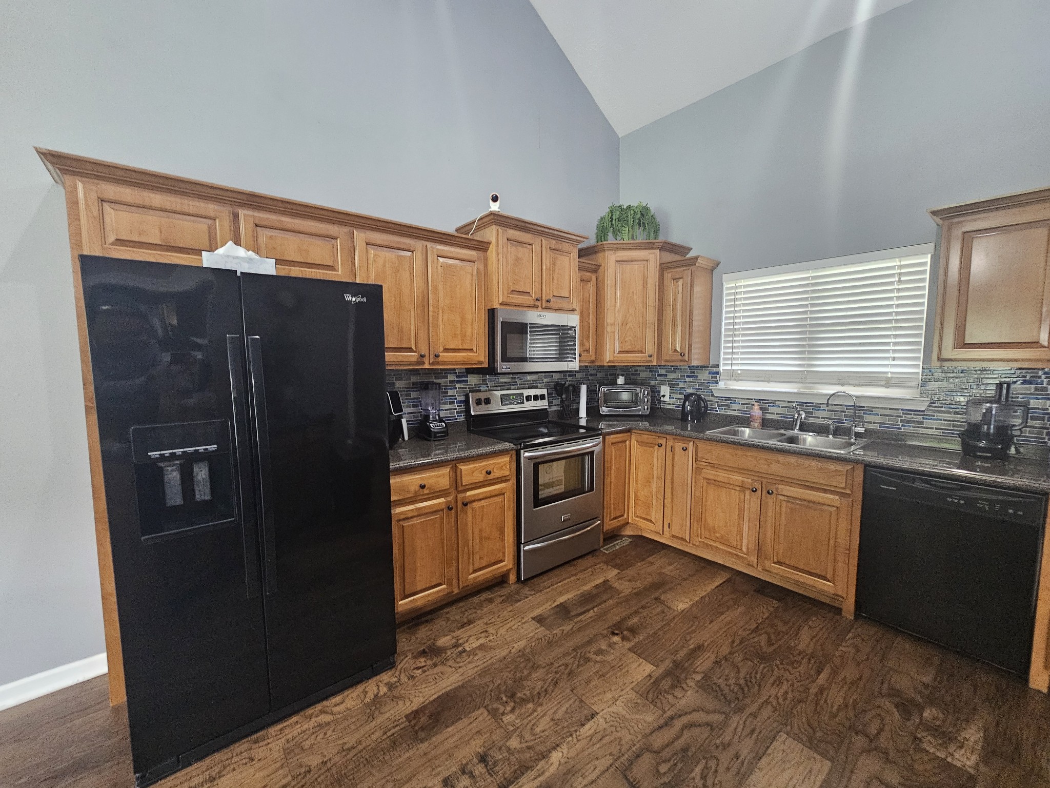 328 Airport Road Portland, TN 37148 - Photo 33 of 50 a kitchen with granite countertop a refrigerator stove top oven and sink