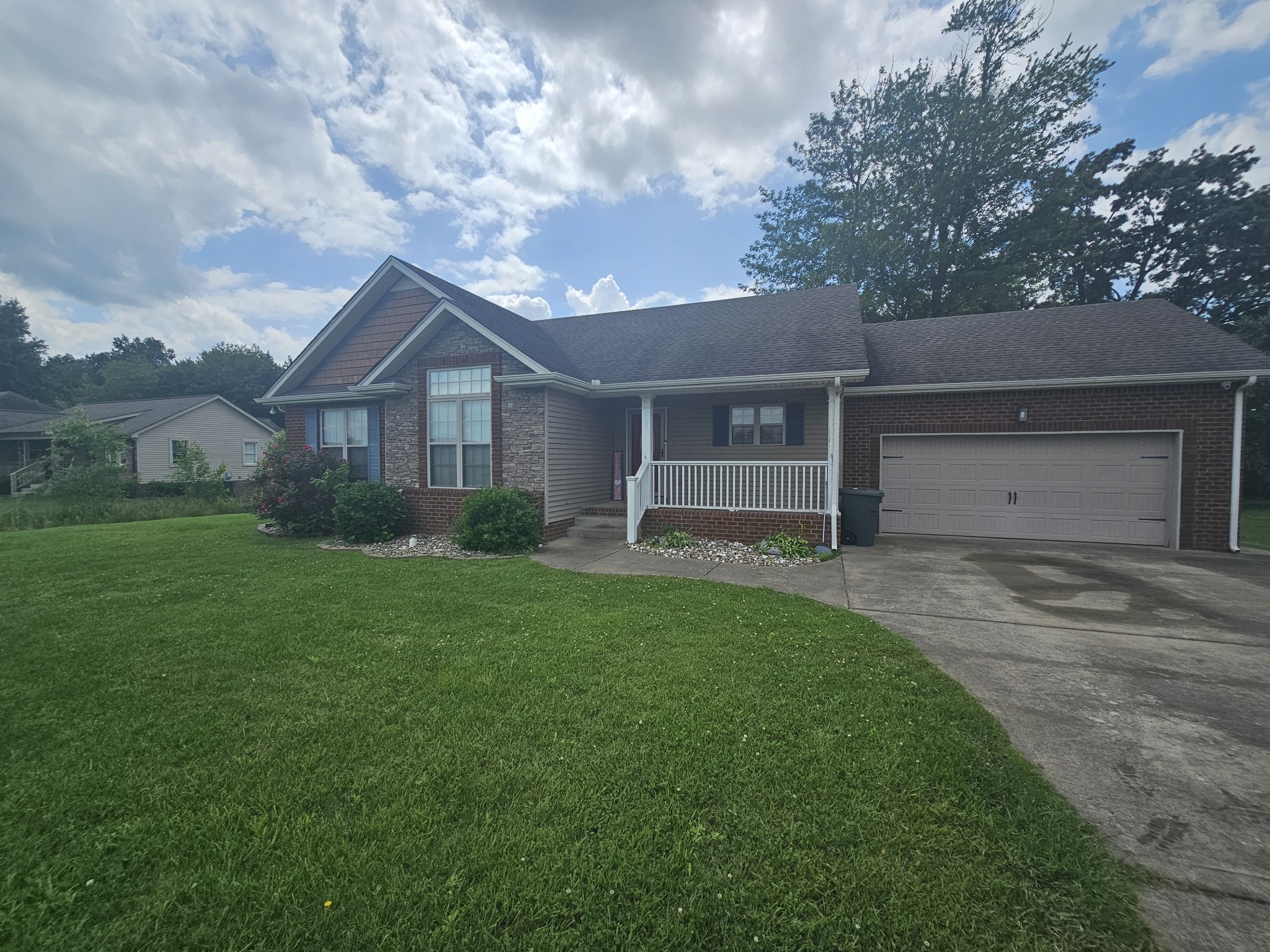 328 Airport Road Portland, TN 37148 - Photo 4 of 50 a front view of a house with a yard and garage