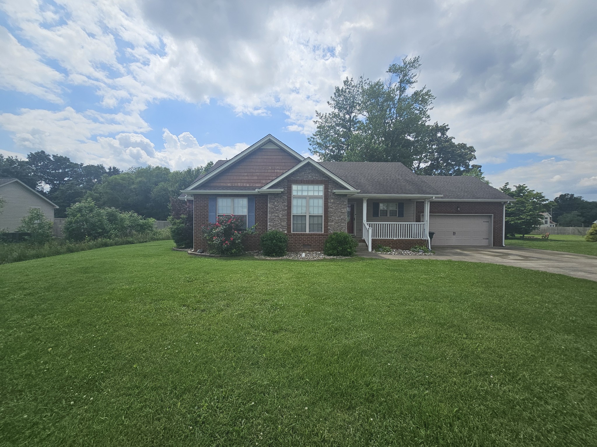 328 Airport Road Portland, TN 37148 - Photo 9 of 50 a view of a house with a big yard potted plants and large tree