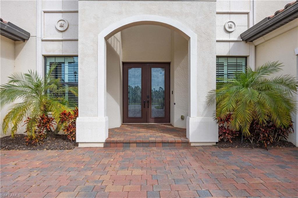 9852 Corso Bello Drive Naples, FL 34113 - Photo 13 of 50 Property entrance featuring french doors and stucco siding