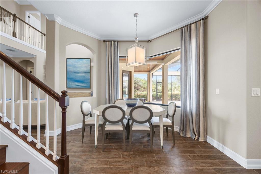 9852 Corso Bello Drive Naples, FL 34113 - Photo 21 of 50 Dining room with ornamental molding, wood finish floors, and stairs