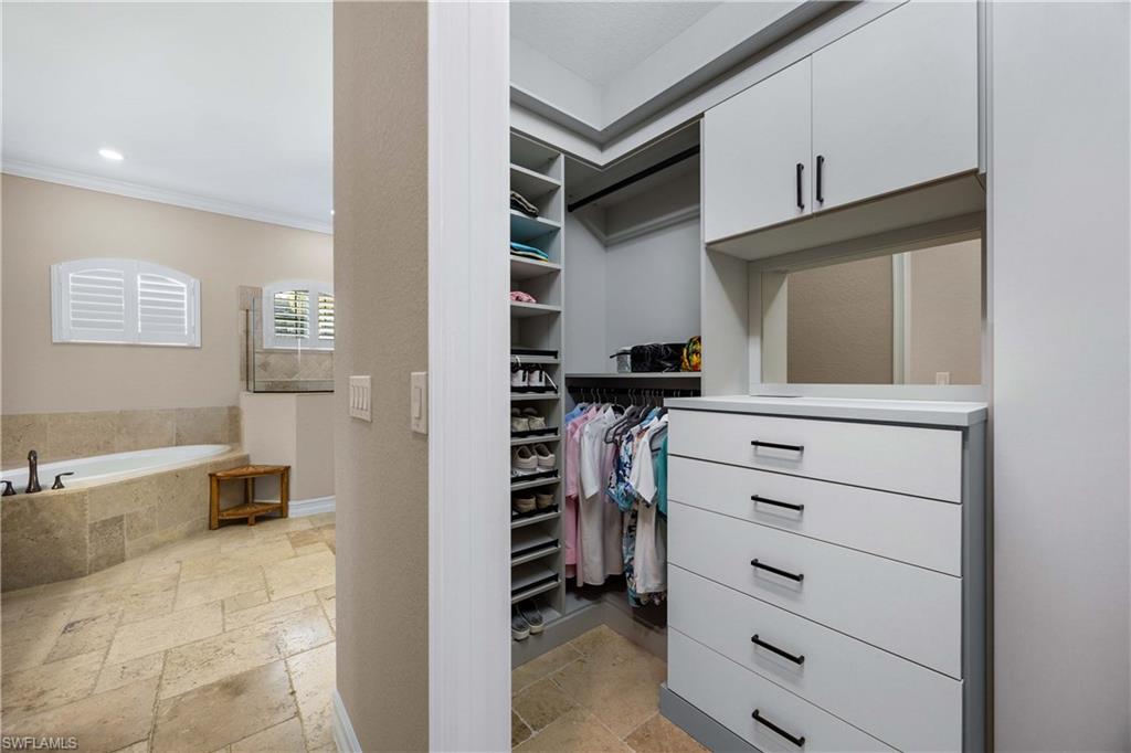 9852 Corso Bello Drive Naples, FL 34113 - Photo 26 of 50 Spacious closet featuring stone tile floors