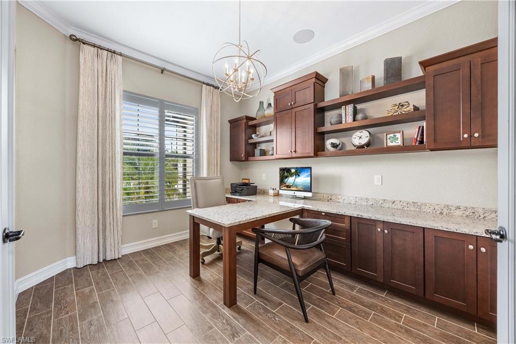 9852 Corso Bello Drive Naples, FL 34113 - Photo 29 of 50 Office featuring ornamental molding, wood finish floors, a chandelier, and built in study area